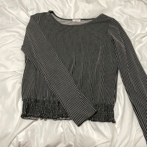 Black and white striped blouse. Cinched bottom with long sleeves.